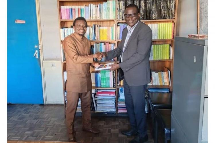 Prof. Etse Sikanku donates his newly published book to the Department of Journalism and Mass Communication and is being received by Prof, Silas Odongo Oriaso.